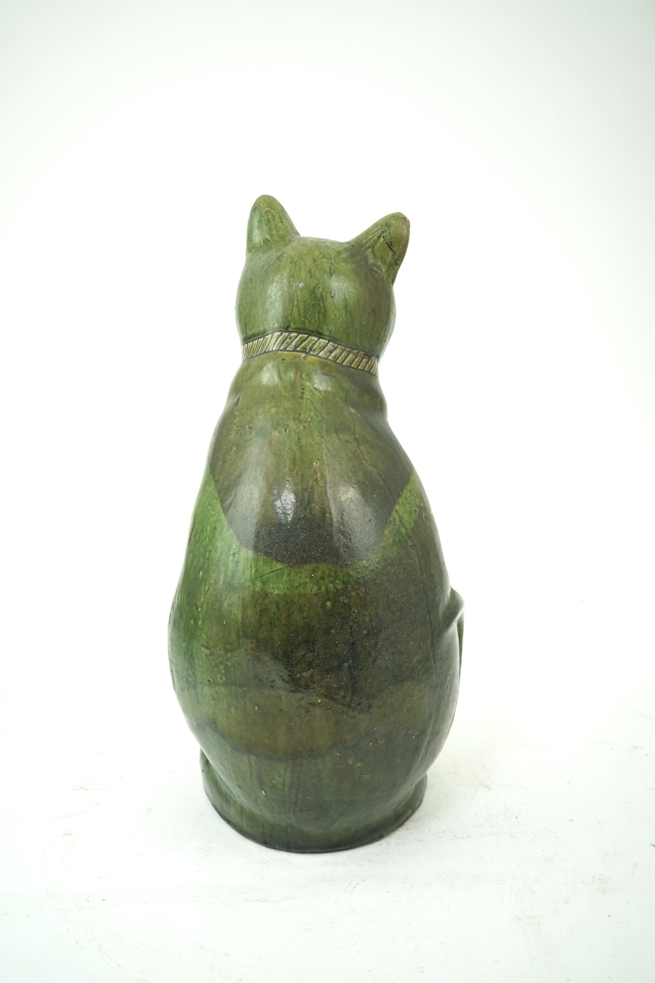 Ewenny Pottery: A large green-glazed figure of a seated cat